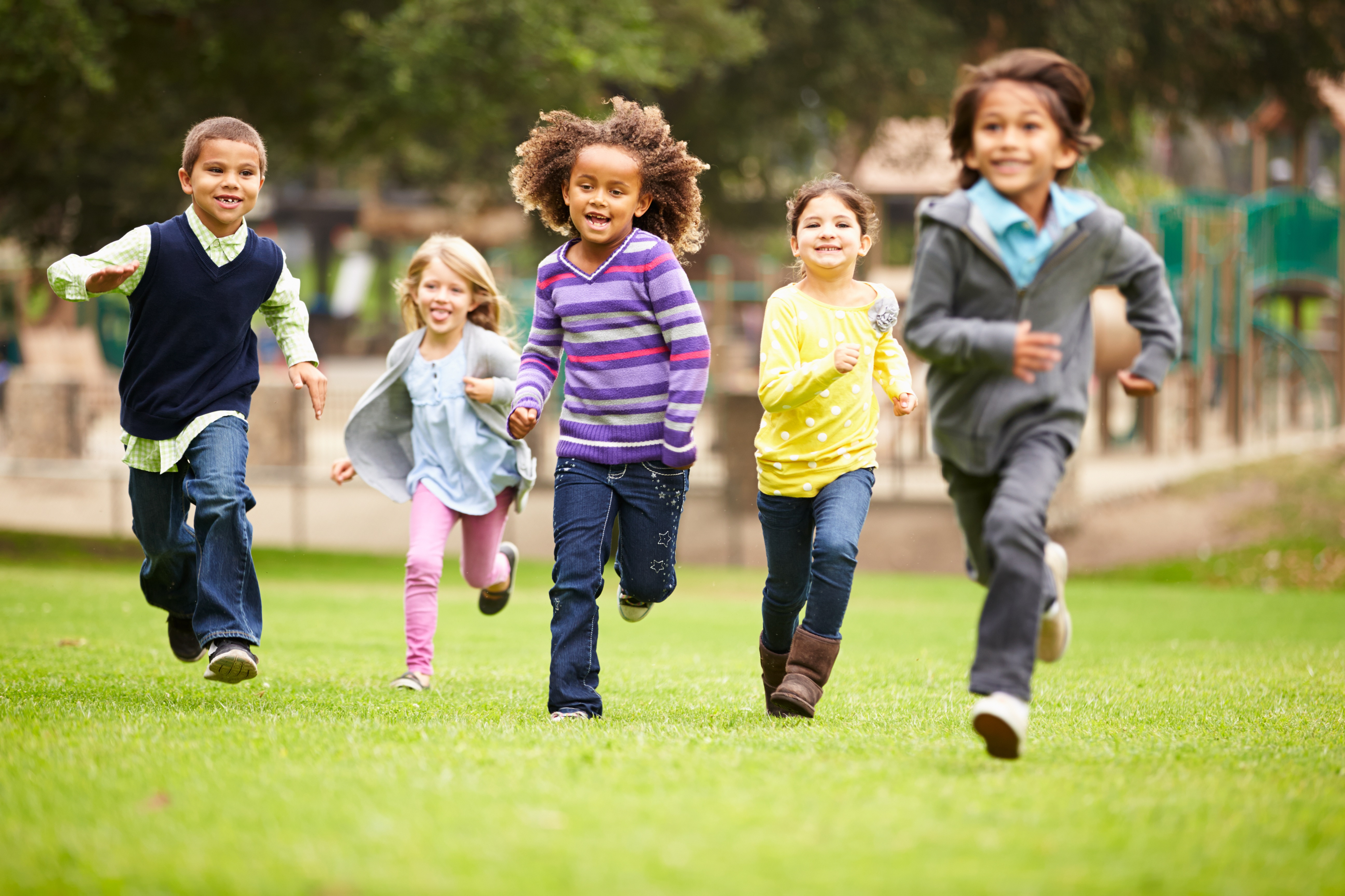 Group Of Young Children Running Towards Camera In Park QUILS